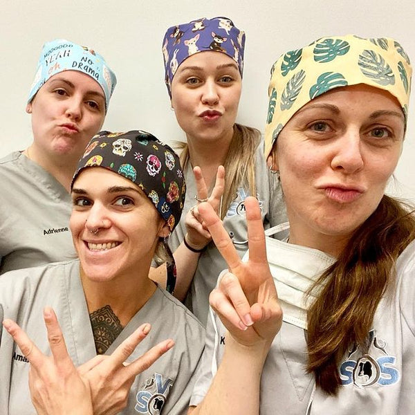 Vet team wearing Dr. Woof surgical scrub caps