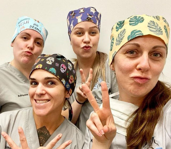 Vet team wearing Dr. Woof surgical scrub caps