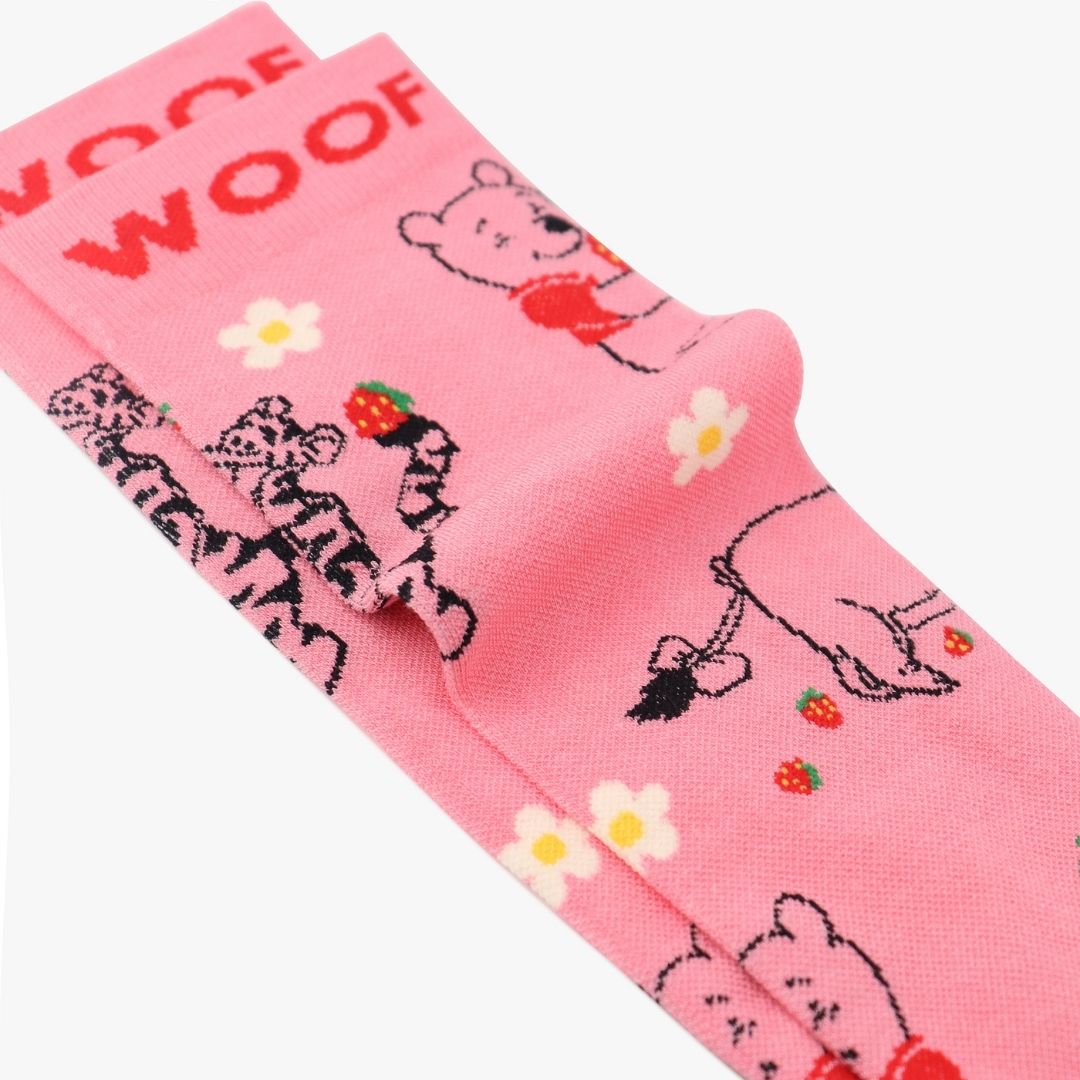 Folded view showing Winnie the Pooh strawberry print on pink compression socks.
