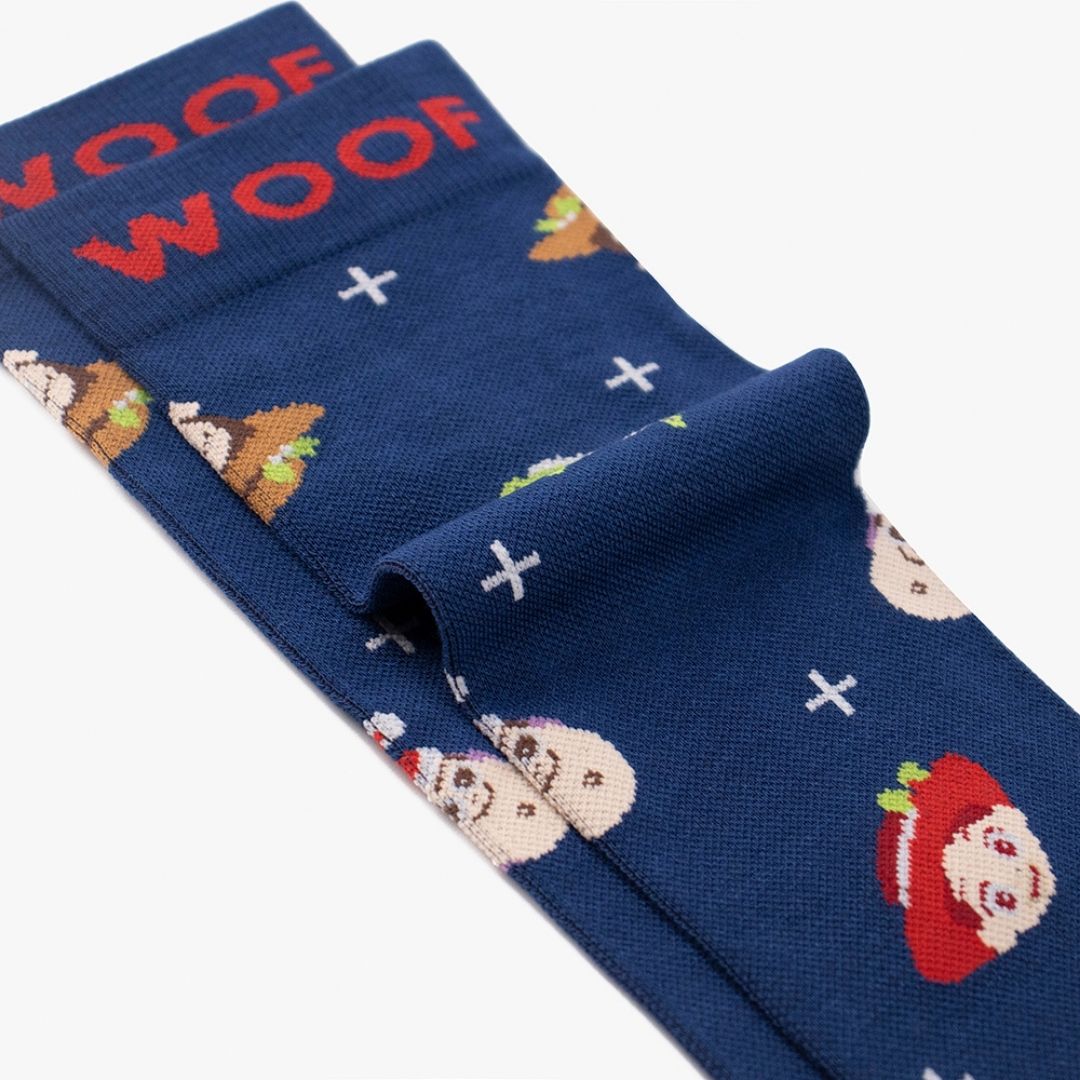 A Toy Story Christmas Bamboo Crew Compression Socks folded neatly to highlight the bold red woven "WOOF" cuff bands and the holiday-themed Pixar character knit pattern layout.  