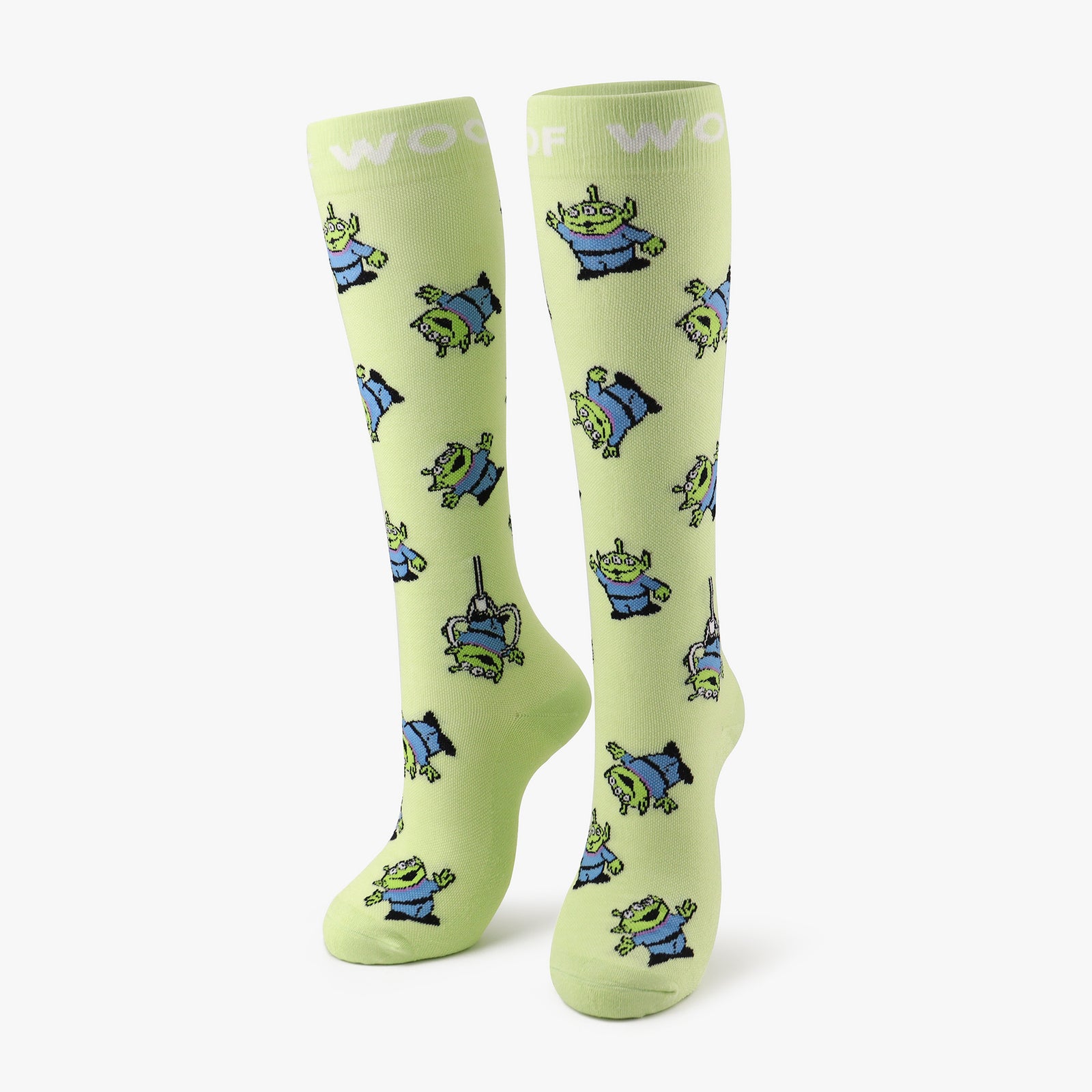 A pair of lime green compression socks featuring the Little Green Men from Disney and Pixar’s Toy Story. 