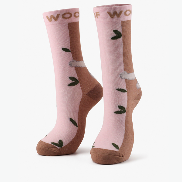 A pair of pink and brown compression crew socks with koala design displayed against a white background.