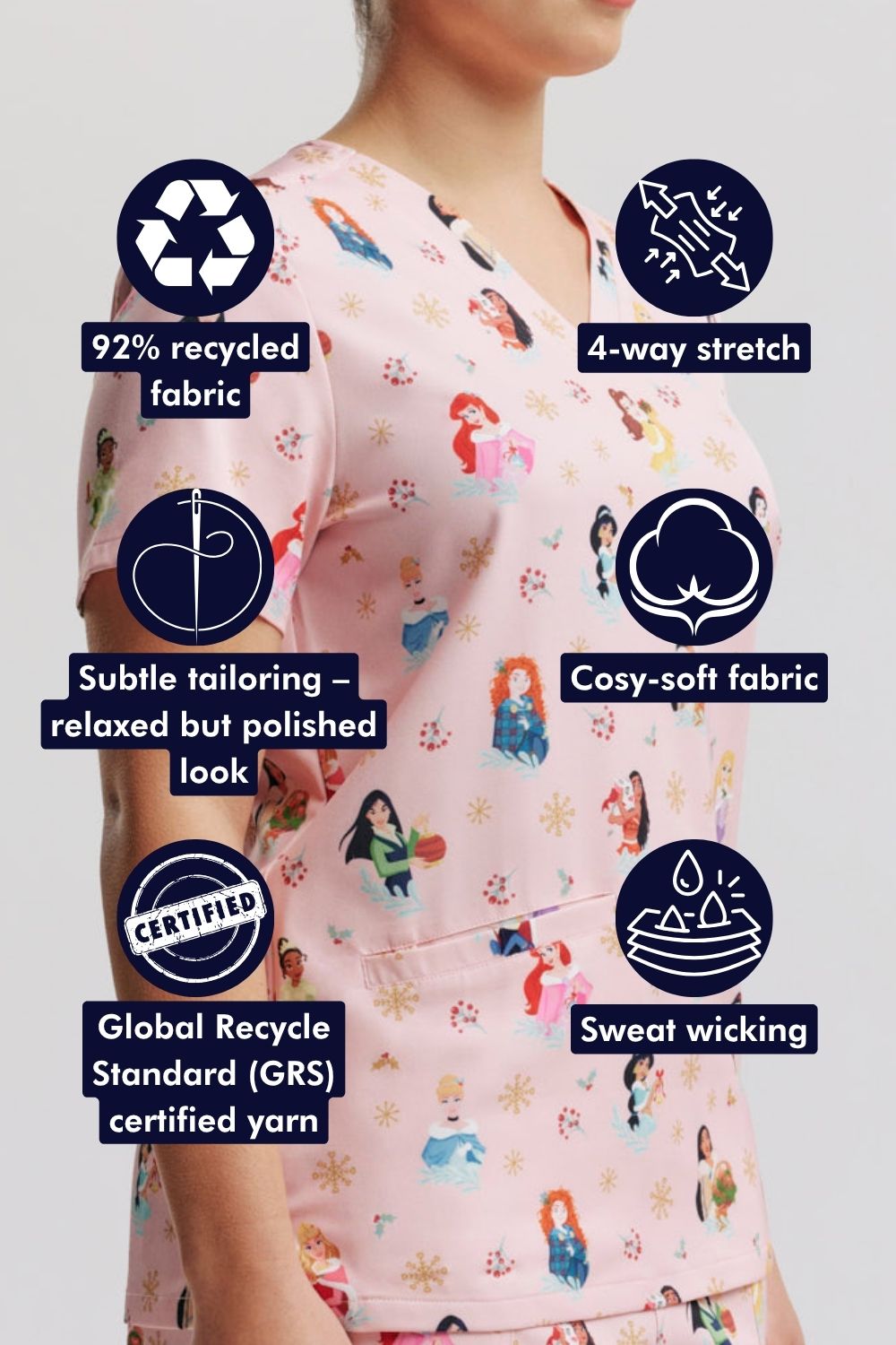 Close-up side view of a female healthcare worker wearing the light pink Disney Princess Christmas scrub top, surrounded by circular feature callout icons highlighting recycled fabric, four-way stretch, subtle tailoring, and sweat-wicking properties.