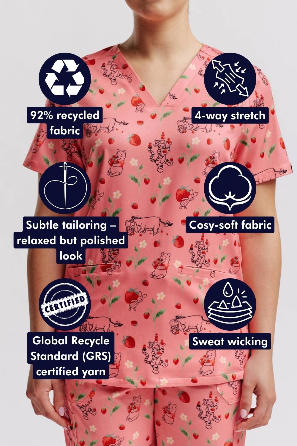 Veterinarian wearing a light pink scrub top with Winnie the Pooh strawberry print, highlighted with fabric feature icons.