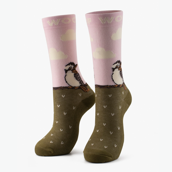 Pair of pink and olive bamboo crew compression socks with kookaburra design standing against a plain white background.