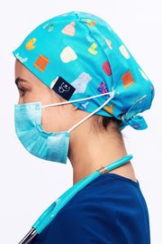 A Nurse wearing a Dr. Woof Goo Goo Gaa Gaa Surgical Scrub Cap 