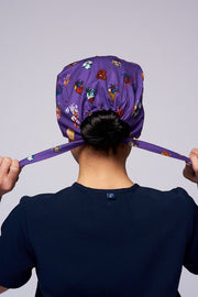 A doctor wearing a Dr. Woof 15 Hearts by Sarai Llamas Surgical Scrub Cap