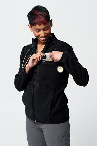A Nurse wearing the Dr. Woof Eight Pocket Tactical Fleece Jacket over their Scrub Uniform