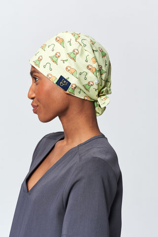 A Dentist Wearing a Dr. Woof Little Sloth Surgical Scrub Cap 